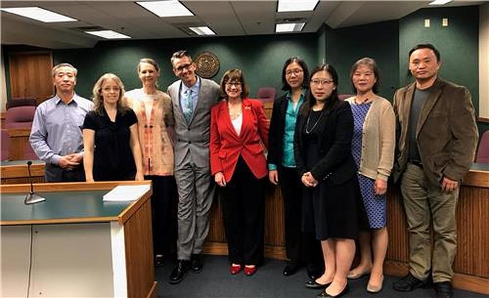 Državna senatorica Missourija, Jill Schupp (peta s lijeve strane), i državni zastupnik Ron Hicks (četvrti s lijeve strane) fotografiraju se s Falun Gong praktikantima koji su 9. aprila 2019. godine svjedočili na saslušanju Odbora za nacionalnu sigurnost SCR br. 6.