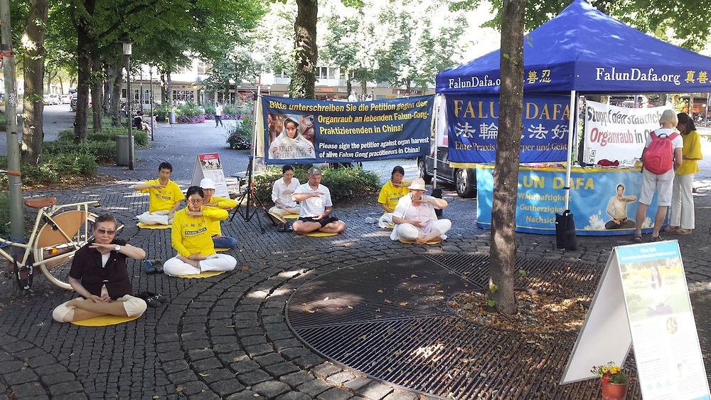 Praktikanti na minhenskom trgu Hohenzollern Platzu 21. avgusta na manifestaciji organizovanoj u svrhu podizanja svijesti javnosti o 21-godišnjem progonu Falun Dafa u Kini.