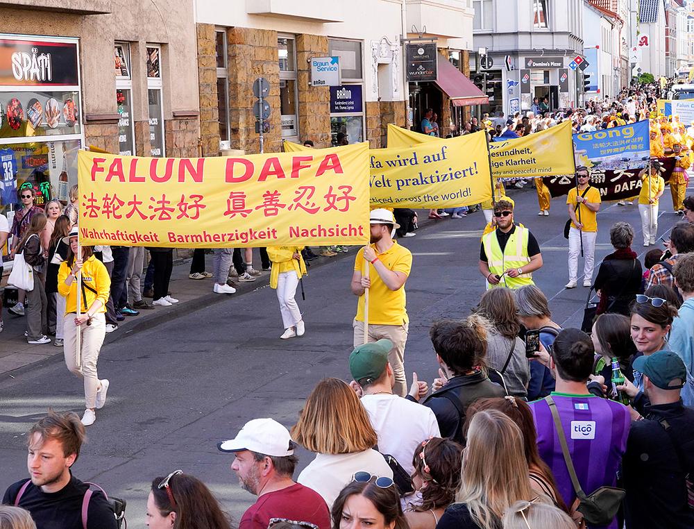  Na transparentima stoji „Falun Dafa je dobra“ i „Istinitost-Blagost-Trpeljivost su dobri“.